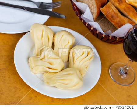 Hearty Georgian dumplings khinkali with meat filling 78524261
