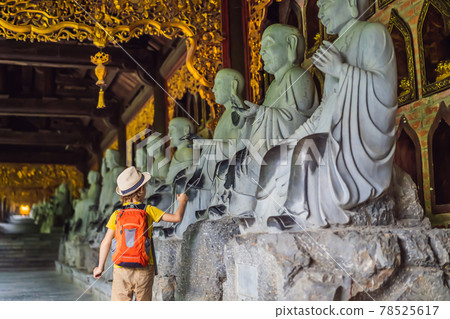 Boy tourist in Temple tower of Bai Dinh pagoda in Ninh Binh, Vietnam. Resumption of tourism in Vietnam after quarantine Coronovirus COVID 19 Boy tourist in Temple tower of Bai Dinh pagoda in Ninh Binh, Vietnam. Resumption of tourism in Vietnam after quarantine Coronovirus COVID 19 78525617