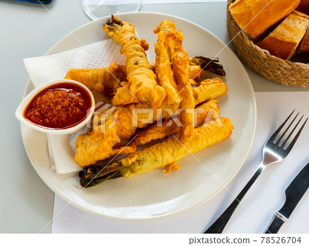 Tempura fried calcots served with Romesco sauce 78526704