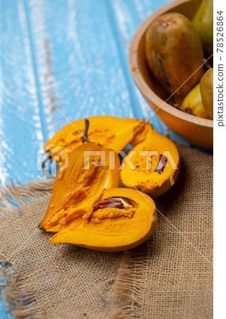 Egg fruit Canistel Yellow Sapote (Pouteria campechiana (Kunth) Baehni) on blue wooden table Egg fruit Canistel Yellow Sapote (Pouteria campechiana (Kunth) Baehni) on blue wooden table 78526864