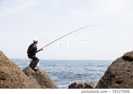 Man fishing on the rocks Man fishing on the rocks 78527006