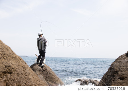 Man fishing on the rocks Man fishing on the rocks 78527016