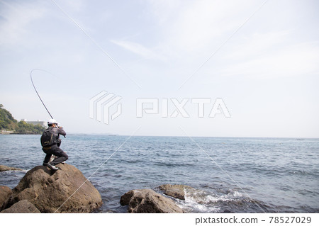 Man fishing on the rocks Man fishing on the rocks 78527029