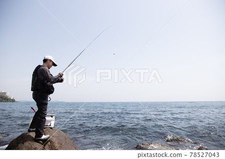 Man fishing on the rocks Man fishing on the rocks 78527043