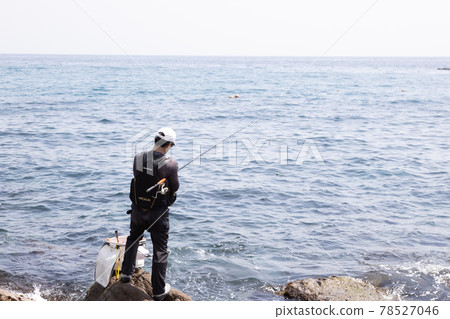 Man fishing on the rocks Man fishing on the rocks 78527046