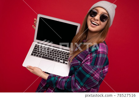 Portrait Photo of beautiful laughing funny smiling blond young woman holding computer laptop with Portrait Photo of beautiful laughing funny smiling blond young woman holding computer laptop with 78527516