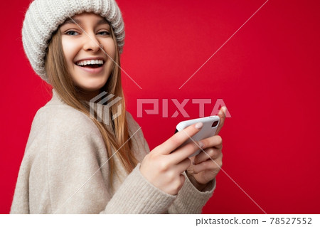 Closeup portrait of sexy smiling happy Beautiful young blonde woman wearing casual beige sweater and 78527552