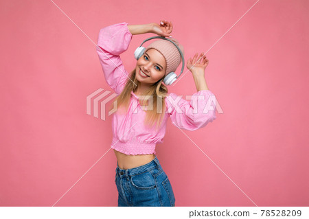 Photo of attractive positive smiling young blonde woman wearing pink blouse and pink hat isolated 78528209
