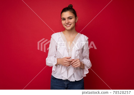 Portrait of positive cheerful fashionable woman in formalwear holding two hands together looking at 78528257