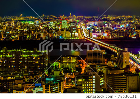A river of light created by cars passing through Shin-Midosuji and the city's night view 78530131