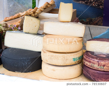 Natural cheeses made in the traditional way in a market stand Natural cheeses made in the traditional way in a market stand 78530607