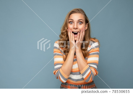 Closeup photo of beautiful attractive shocked amazed surprised young woman with open mouth wearing 78530655