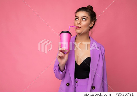 Charming young happy thoughtful brunette woman wearing stylish clothes isolated over colourful Charming young happy thoughtful brunette woman wearing stylish clothes isolated over colourful 78530781