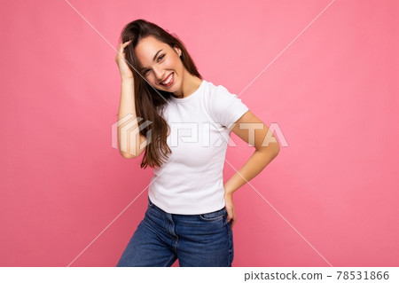 Portrait of positive cheerful fashionable woman in casual t-shirt for mock up isolated on pink 78531866