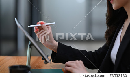 Cropped shot of businesswoman holding stylus pen pointing on digital tablet. Cropped shot of businesswoman holding stylus pen pointing on digital tablet. 78532180