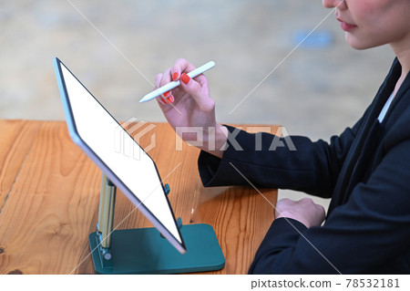 Cropped shot of businesswoman checking information on digital tablet. Cropped shot of businesswoman checking information on digital tablet. 78532181