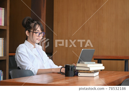 Young asian woman using laptop computer in the modern cafe. 78532186