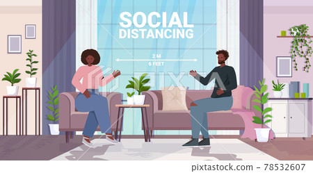 couple discussing at home man woman keeping distance to prevent coronavirus social distancing 78532607