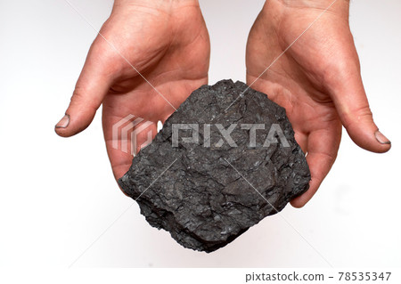 Miner's hands with a big piece of coal. Male hand with coal. Miner's hands with a big piece of coal. Male hand with coal. 78535347