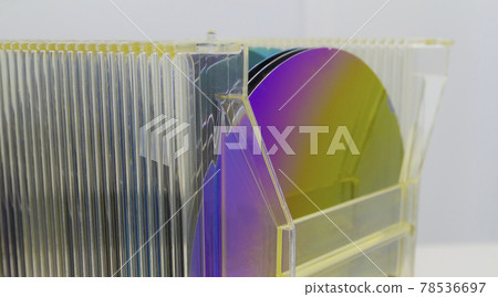Silicon Wafers in plastic storage box in clear room of semiconductor foundry. Silicon Wafers in plastic storage box in clear room of semiconductor foundry. 78536697