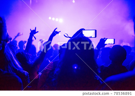 Raised arms holding smart phones to recording a live concert Raised arms holding smart phones to recording a live concert 78536891