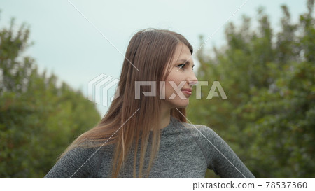 Young woman portrait. Portrait of happy beautiful positive fit girl, young slim fitness sports woman in sportswear, top outdoors going to training in park and smiling, looking at camera. Sport outdoor Young woman portrait. Portrait of happy beautiful positive fit girl, young slim fitness sports woman in sportswear, top outdoors going to training in park and smiling, looking at camera. Sport outdoor 78537360