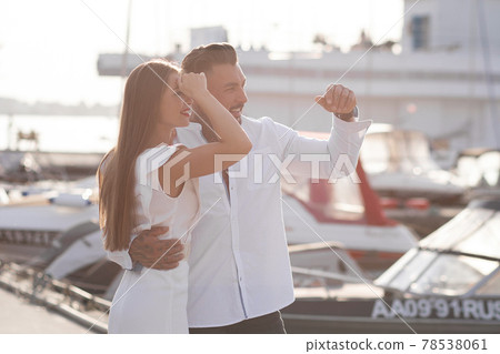 Couple standing in port in summer 78538061