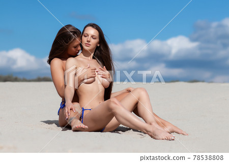 Sexy girlfriends with bare breast on beach 78538808