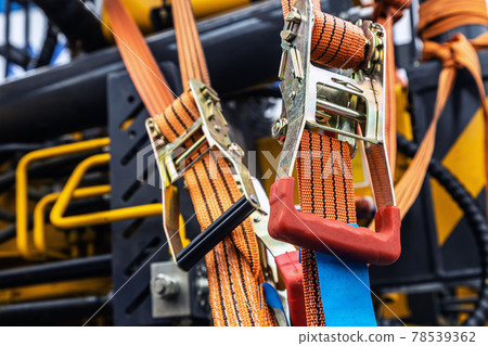 tension safety belts with mechanical locks. stretch textile slings hold tension safety belts with mechanical locks. stretch textile slings hold 78539362