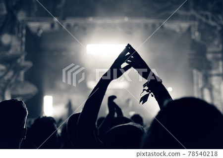 Crowd at a music concert, audience raising hands up, toned Crowd at a music concert, audience raising hands up, toned 78540218