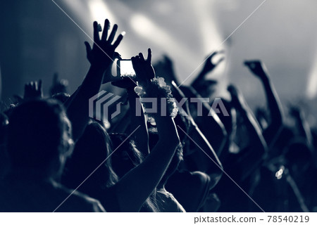 Crowd at a music concert, audience raising hands up, toned Crowd at a music concert, audience raising hands up, toned 78540219