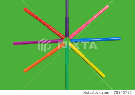 felt pens lying cap to cap on a green surface felt pens lying cap to cap on a green surface 78540755