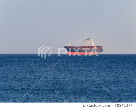 Container cargo ship anchored off the harbor awaiting loading Container cargo ship anchored off the harbor awaiting loading 78541374
