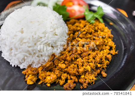 Thai Stir-fried pork with yellow curry paste on white rice. Thai Stir-fried pork with yellow curry paste on white rice. 78541841