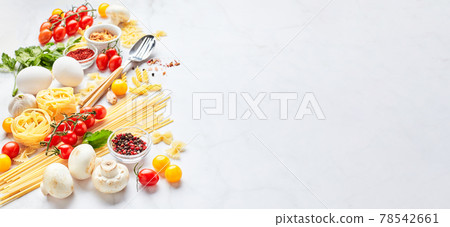 Food background with place for text, with different kinds of pasta, tomatoes, herbs, mushrooms, eggs, seasonings scattered on light marble background. 78542661
