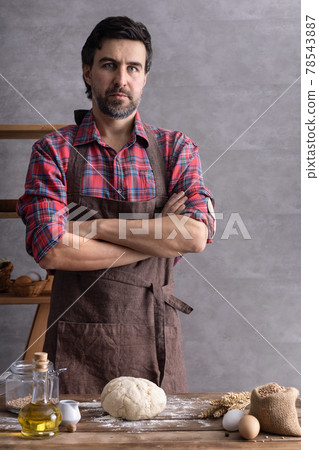 Baker man making dough and bakery ingredients for homemade bread cooking on table. Bakery concept Baker man making dough and bakery ingredients for homemade bread cooking on table. Bakery concept 78543887