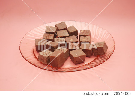 dark chocolate on a plate on pink background dark chocolate on a plate on pink background 78544003