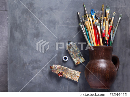 Paint brush and painters palette on table Stock Photo by ©seregam