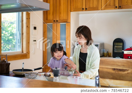 Girl cooking with her mother Girl cooking with her mother 78546722