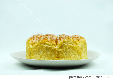 Isolated round shape a loaf of bread, sugar topping on a plate against white background. Isolated round shape a loaf of bread, sugar topping on a plate against white background. 78548660