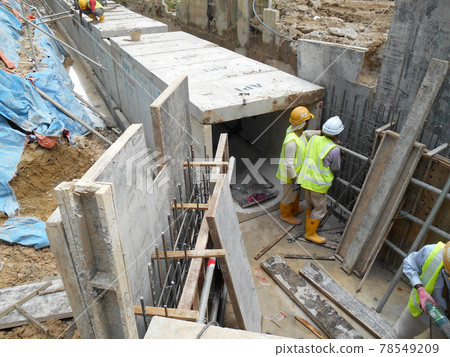 SEREMBAN, MALAYSIA -FEBRUARY 24, 2017: Underground utility and services pipe lay by workers at the construction site. SEREMBAN, MALAYSIA -FEBRUARY 24, 2017: Underground utility and services pipe lay by workers at the construction site. 78549209
