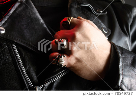 Biker in leather jacket and steel rings. Biker in leather jacket and steel rings. 78549727