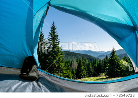 Mountain forest view from a camping tent. Mountain forest view from a camping tent. 78549728