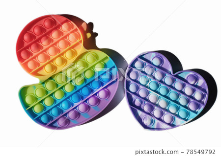 children pop it toys isolated, duck and heart shaped fidgets rainbow colored. multicolor silicone bubbles toys for relax and antistress. tik tok trend. children pop it toys isolated, duck and heart shaped fidgets rainbow colored. multicolor silicone bubbles toys for relax and antistress. tik tok trend. 78549792