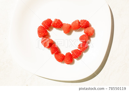 Raspberries in shape of heart. 78550119