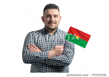 White guy holding a flag of Burkina Faso smiling confident with crossed arms isolated on a white background 78550296