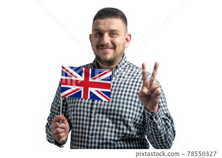 White guy holding a flag of United Kingdom and shows two fingers isolated on a white background White guy holding a flag of United Kingdom and shows two fingers isolated on a white background 78550327