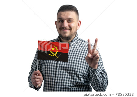White guy holding a flag of Angola and shows two fingers isolated on a white background 78550338
