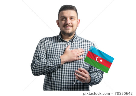 White guy holding a flag of Azerbaijan and holds his hand on his heart isolated on a white background With love to Azerbaijan White guy holding a flag of Azerbaijan and holds his hand on his heart isolated on a white background With love to Azerbaijan 78550642