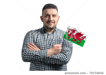 White guy holding a flag of Wales smiling confident with crossed arms isolated on a white background White guy holding a flag of Wales smiling confident with crossed arms isolated on a white background 78550648